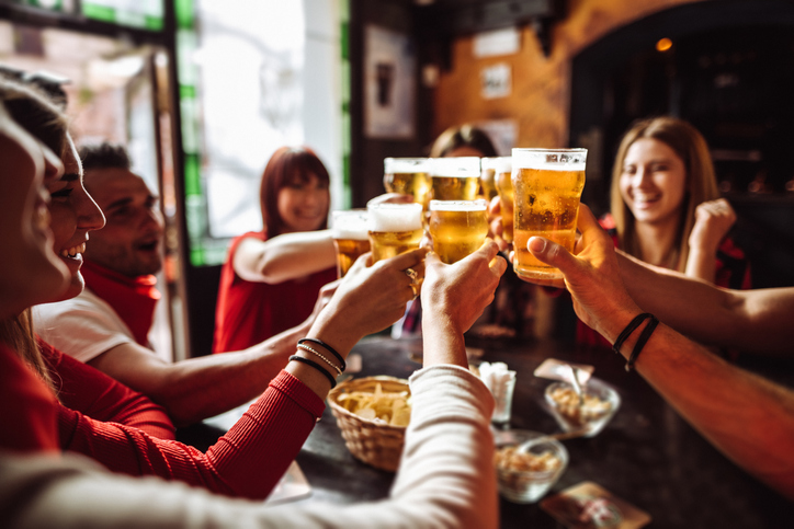 Blog 5 anniversary celebration with people toasting glasses of beer